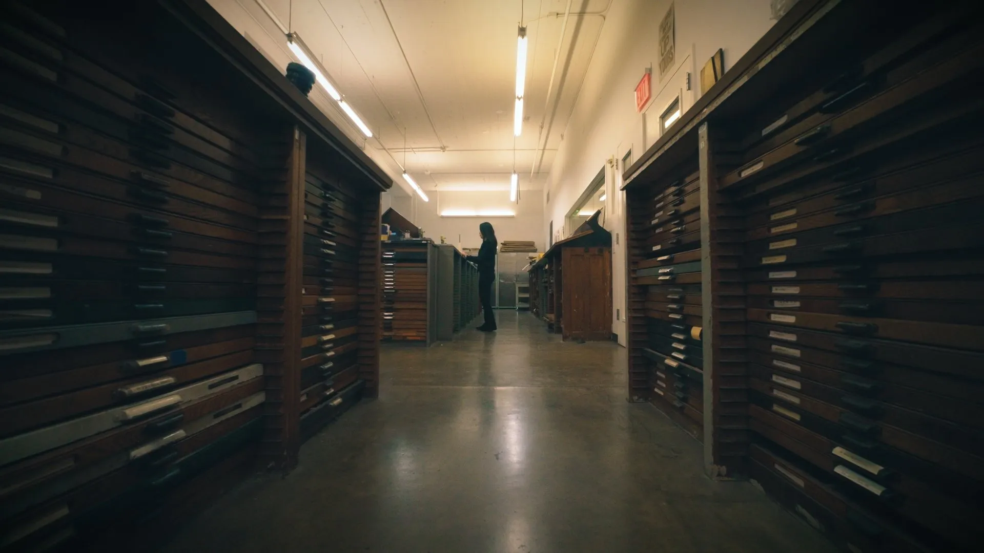 Long corridor lined with shelves of archival type drawers.